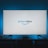 A television screen displays the Prime Video logo, situated on an entertainment unit in a dimly lit room. The room is illuminated with a subtle blue backlight, creating a calming atmosphere. Two small decorative items, resembling mushrooms, are placed on either side of the unit.