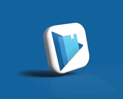 A 3D icon with a play button symbol and a book graphic is centered against a solid blue background. The icon is designed in white and shades of blue, with a modern and sleek appearance.